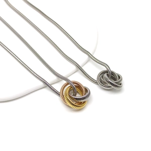 Detailed close-up of triple-ring pendant necklaces with textured snake bone chain