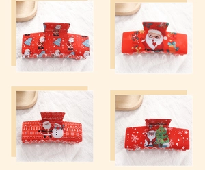 Detail of red Christmas hair claws with Santa, snowman, and snowflake holiday patterns