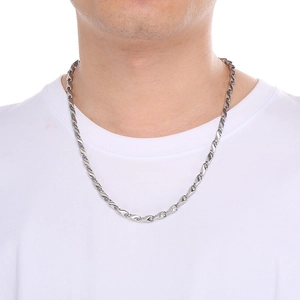 Close-up of hip-hop silver stainless steel chain necklace worn on a male model neck