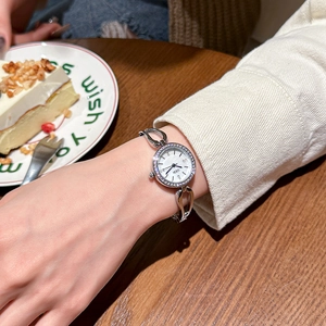 Elegant silver bracelet watch for women with rhinestone bezel and mother of pearl dial