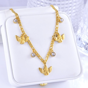 Close-up of golden angel pendant necklace with round zircon charms on jewelry box display
