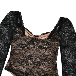 Detailed close-up of black lace bodysuit with fishbone mesh and beige lining texture