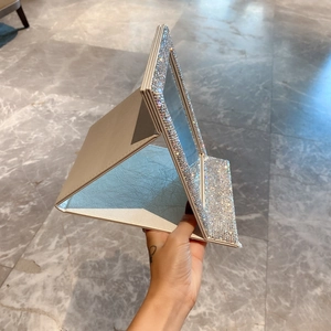Detail of glittery PU leather folding mirror with rhinestones on beige surface