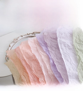 Close-up of pastel floral tissue paper with rose pattern and crinkled texture