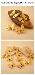 Detailed close-up of dragonfly earrings with golden plating and assorted natural stones