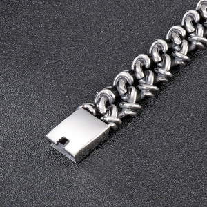 Macro shot of silver industrial style thick chain bracelet with a square clasp mechanism