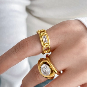 Detail of 18K gold-plated titanium rings with large oval zircon and chain design style