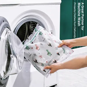 Thick laundry bag with cartoon llama pattern being placed into washing machine
