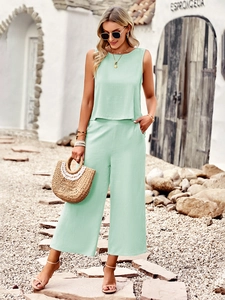 Detail of mint green sleeveless top and wide-leg cropped pants with light breathable fabric