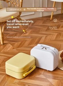 Detail view of small hardshell vanity cases in yellow and cream with dual metal zippers