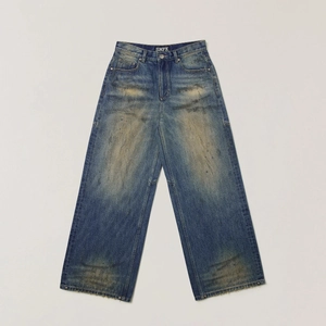Macro view of distressed vintage blue denim with heavy wash and stain texture details