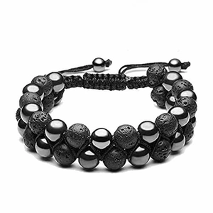 Macro detail of double-row woven bracelet with black lava rock and gray hematite beads