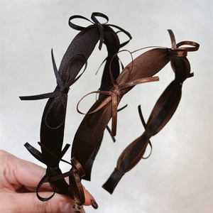 Elegant French satin bow headband in black and coffee brown for a stylish woman hair look