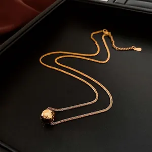 Minimalist 18K gold plated necklace with hammered spherical pendant on black leather base