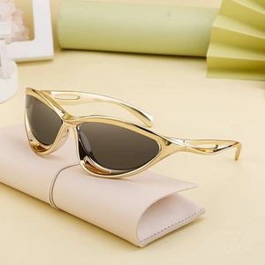 Y2K futuristic cat-eye sunglasses in shiny gold frame with dark grey lenses on leather case