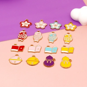 Flat lay of colorful enamel cherry blossom and koi fish charms for DIY jewelry crafts