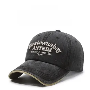 Detailed close-up of dark grey washed cotton baseball cap with vintage 3D letter embroidery