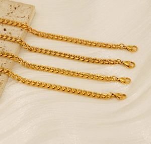 Detailed view of four 18K gold-plated stainless steel Cuban chains with lobster clasps