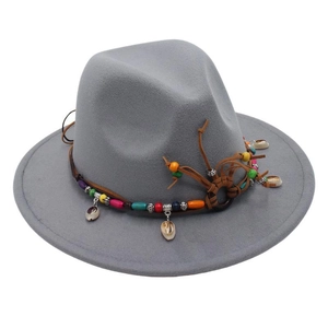 Close-up of light grey wool fedora with bohemian colorful beaded band and small shells