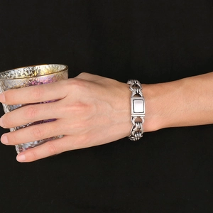 Detail of silver men's punk chain bracelet with industrial interlocking link design