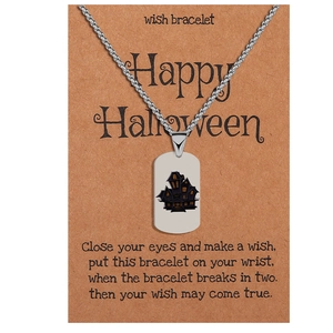Detail view of Halloween ghost house necklace on a brown Kraft paper gift card