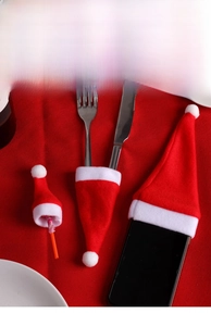 Mini Christmas hats used as lollipop toppers and cutlery holders for festive table decor