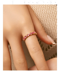 Macro view of S925 silver gold-plated ring with red marquise stones and round diamonds