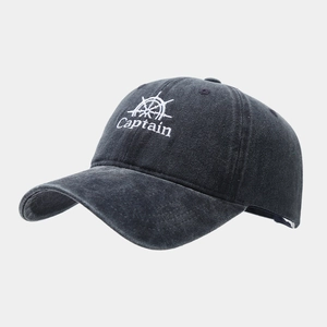 Detailed close-up of the Captain nautical embroidery on a washed grey vintage baseball cap