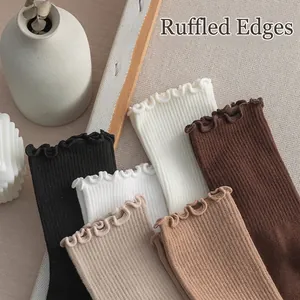 Women's knit mid-calf socks with ruffle trim and vertical ribbed texture in earth tones