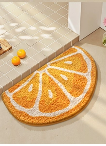 Detail of semi-circular orange slice bath mat with high-absorbent flocked texture