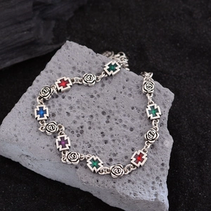 Vintage silver-tone bracelet featuring colorful cross charms and carved rose links