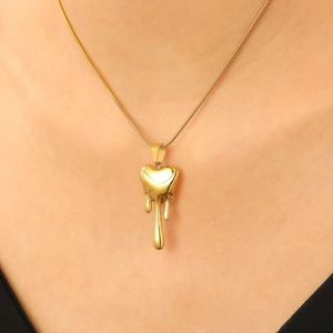 Polished gold lava heart pendant necklace on model showing metallic mirror texture
