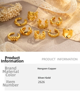 Detailed view of assorted golden C-shaped ear cuffs on vintage background paper