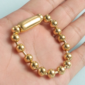 Polished 8mm gold stainless steel bead chain bracelet with a smooth cylindrical accent