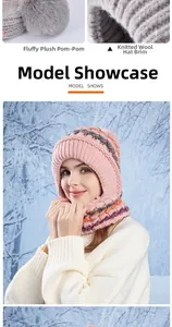 Detail of pink winter knitted hat with fluffy grey pompom and warm thermal lining
