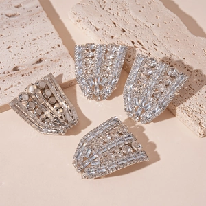 Luxury geometric silver post earrings with sparkling zircons on travertine stone