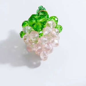 Macro view of handmade grape charm with faceted crystal beads and golden metal ring