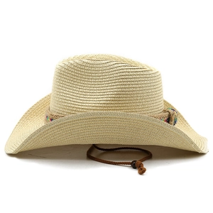 Detail of light beige woven straw cowboy hat with colorful ethnic rope and chin strap