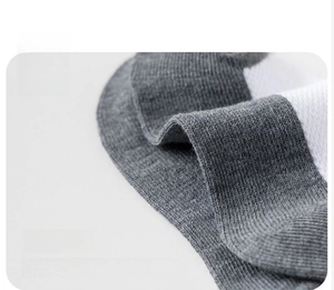 Close-up of breathable knit fabric texture with grey and white color splicing