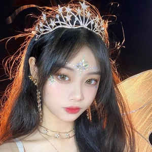 Close-up of sparkling star crown and facial rhinestone stickers for music festivals