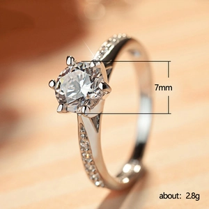 Classic six-prong zircon ring with 7mm center stone and side accents on silver band