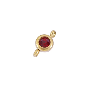 Macro detail of red birthstone pendant with gold frame and double jump rings for DIY jewelry