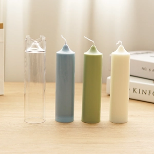 Church spire pillar candle mold with finished blue, green, and cream wax candles