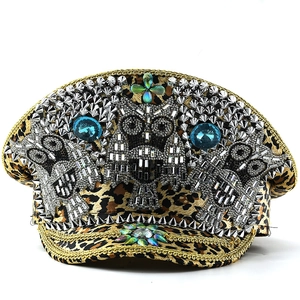Detail of leopard print captain hat with punk silver studs and rhinestone owl motifs