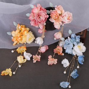 Three pairs of floral hairpins with silk flowers and pearl tassels in pink, yellow and blue