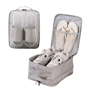 Internal mesh compartment of the grey travel shoe bag showing sneakers and flip-flops