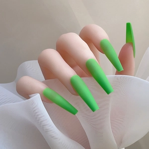 Vue détaillée de faux ongles longs ballerine vert fluo mat sur une main de modèle