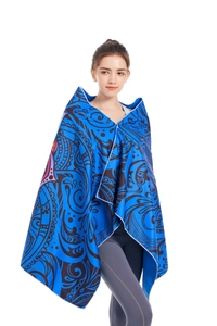 Detail view of double-sided microfiber beach towel with blue mandala pattern and overlocked edges