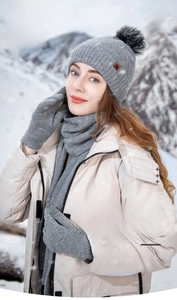 Outdoor shot of thick grey wool knit hat, scarf and gloves set for winter warmth