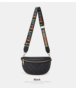 Detail of black quilted waist bag with colorful LOVE embroidered strap and gold zipper